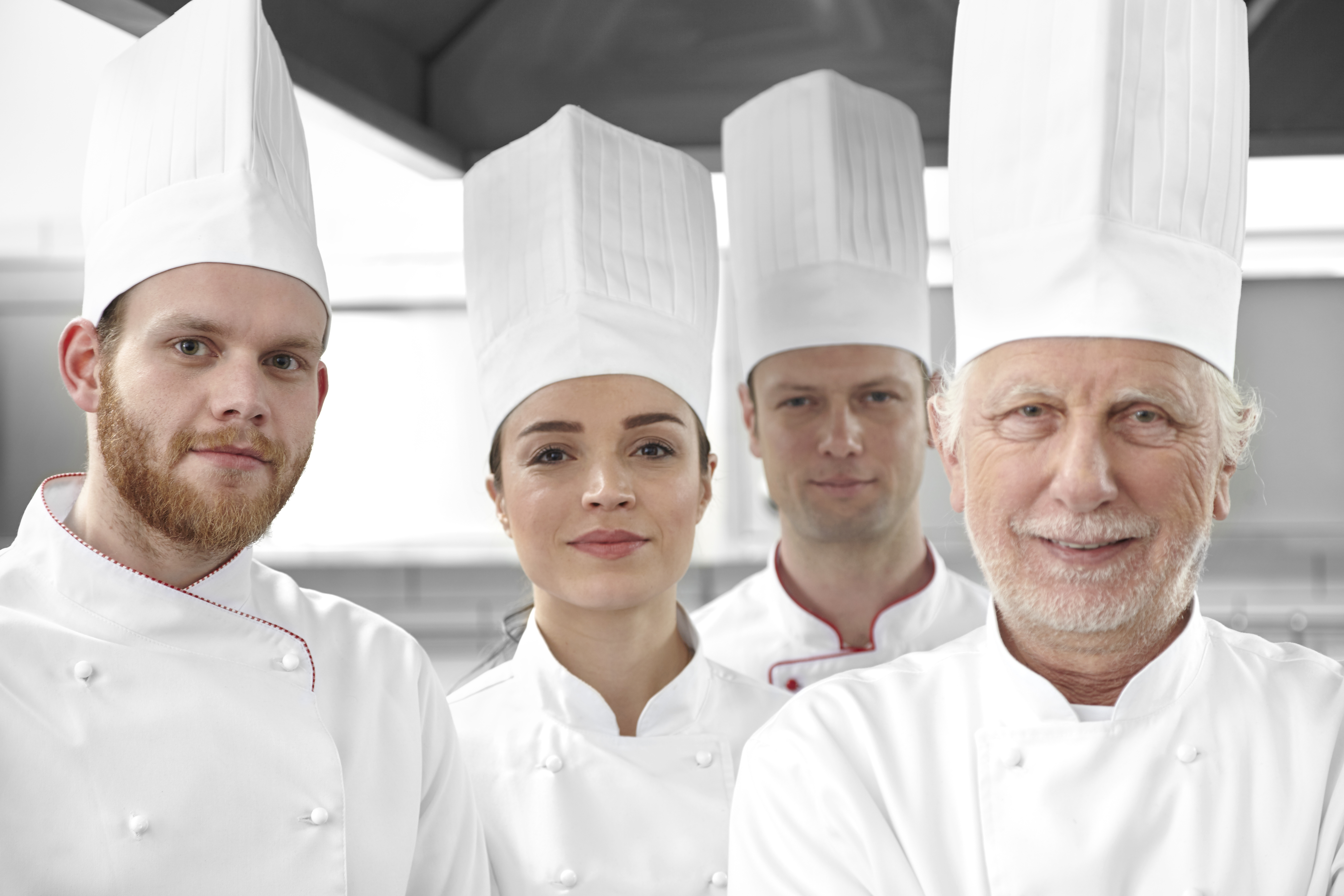 Smiling chefs looking at camera